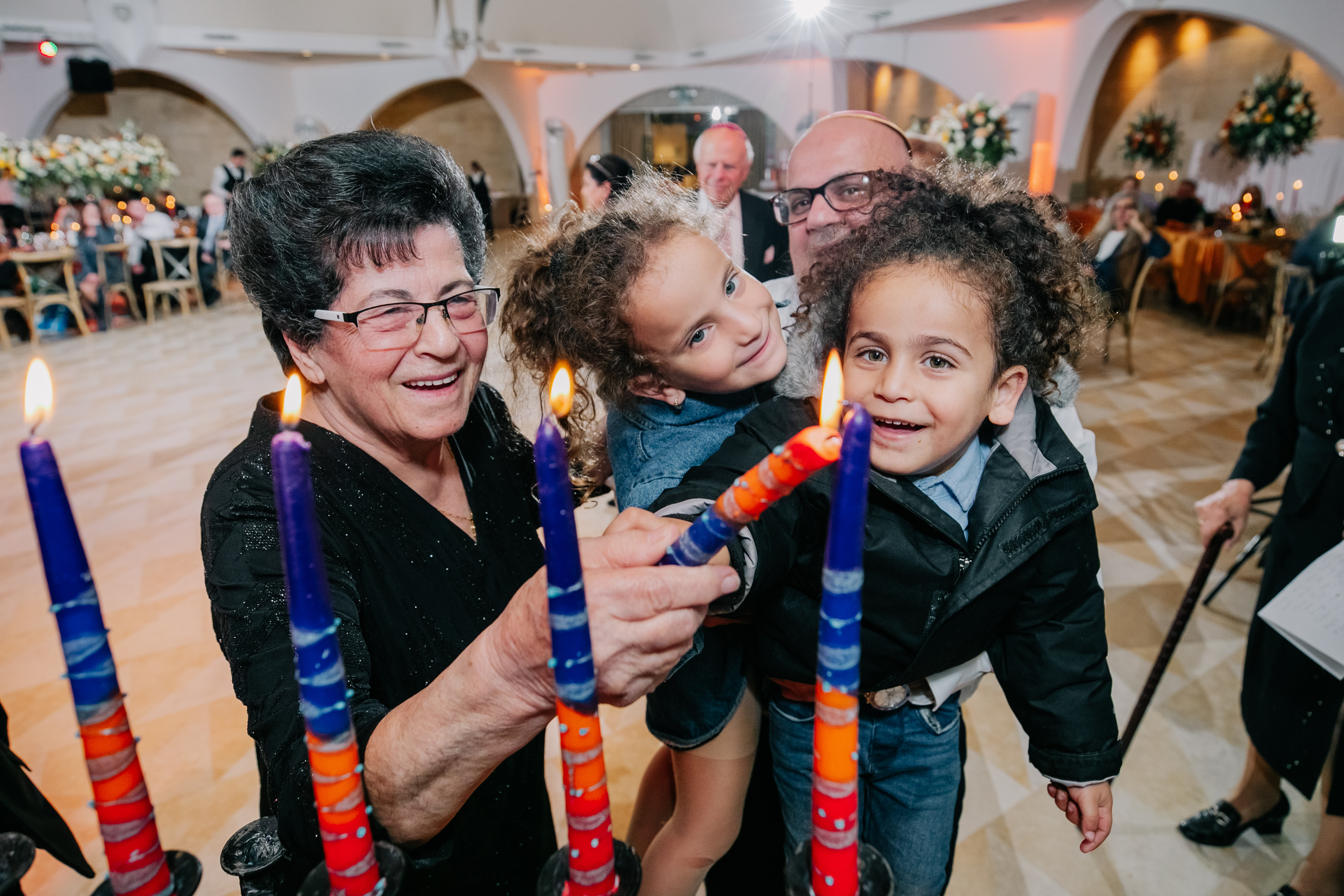 Family sharing a candle-lighting moment at a celebration