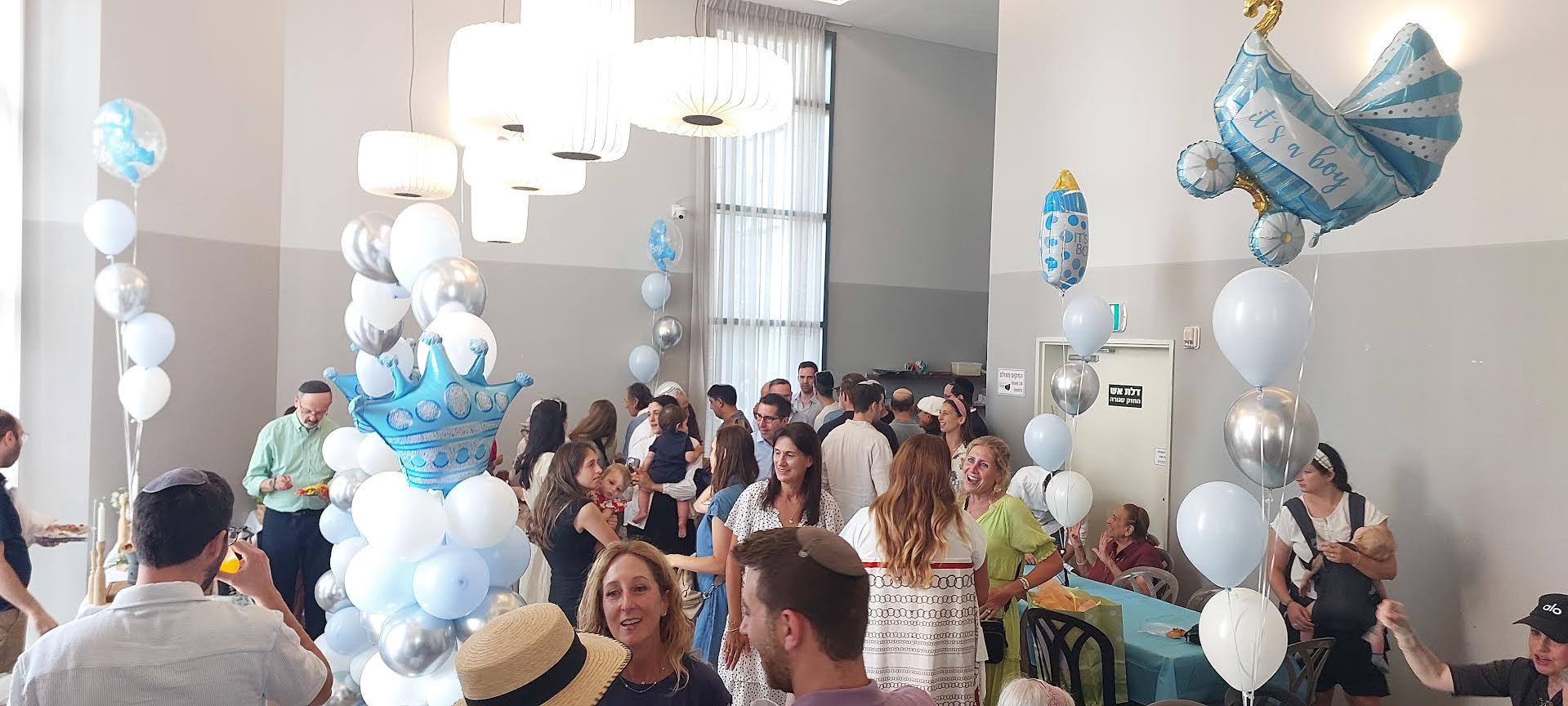 Family and blue balloons at a baby celebration
