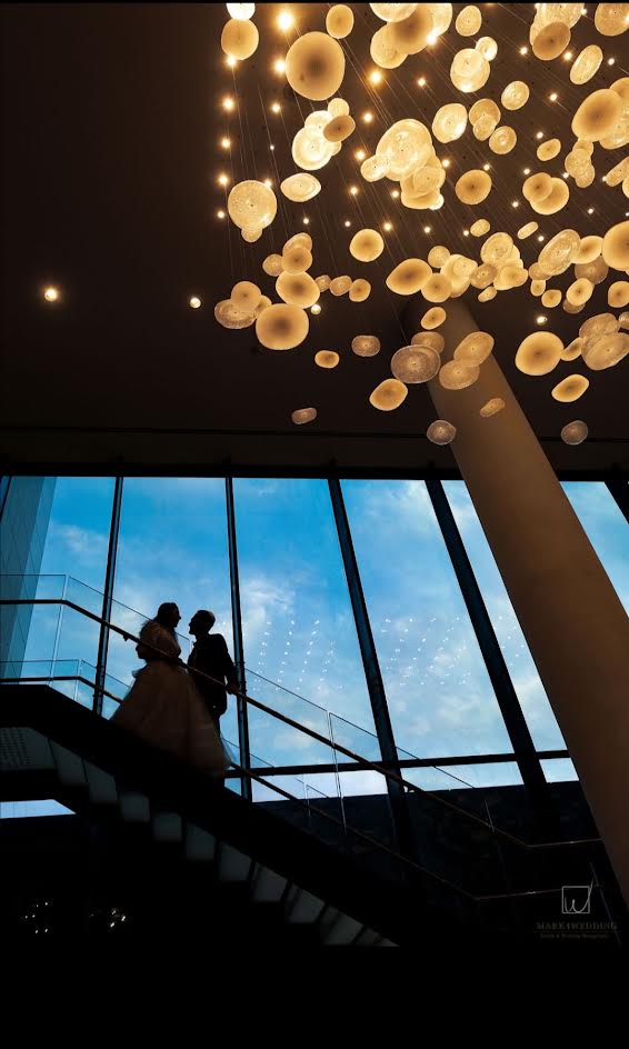 A dramatic wedding beneath golden lights