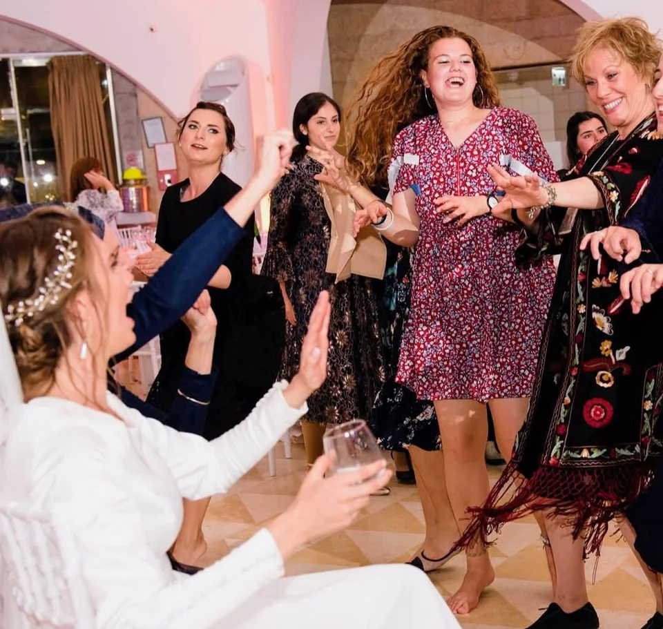 Risa dancing with guests at a wedding celebration