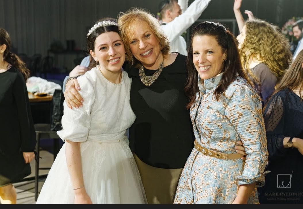 Risa celebrating with the bride and Robin Coopersmith at the wedding